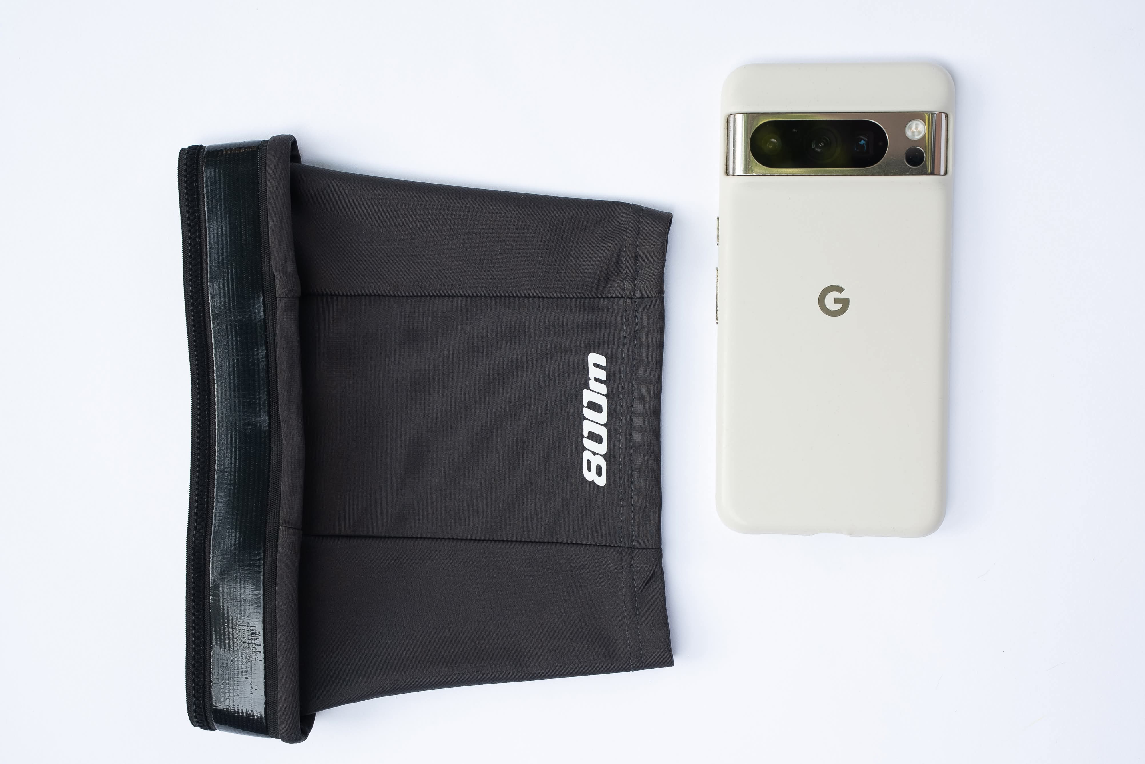 Google Pixel phone shown inside the pocket of the black 800m THIGHBAND running phone holder.