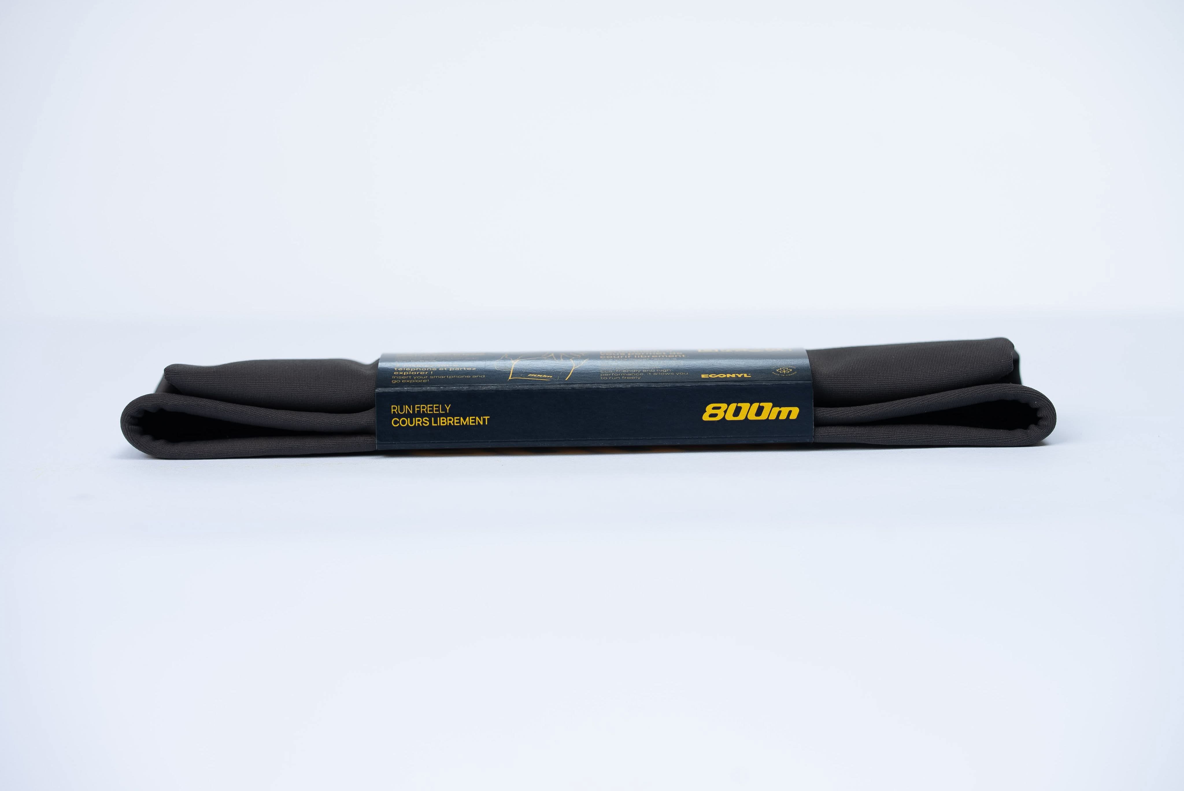 Folded black 800m THIGHBAND running phone holder with packaging.